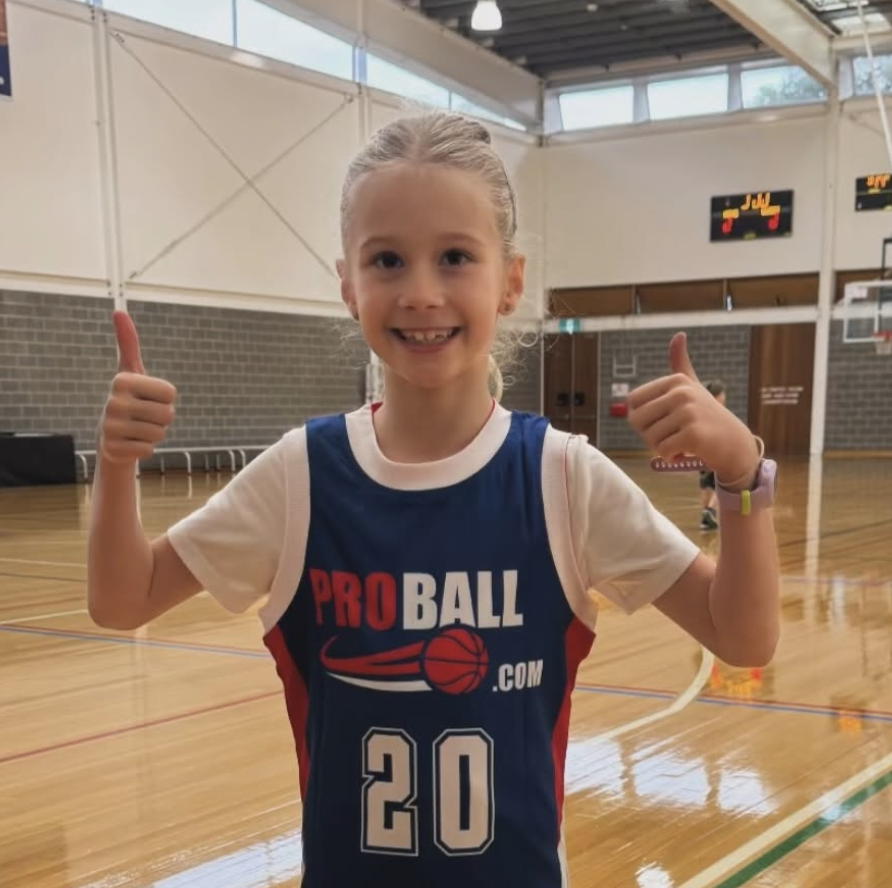 Mila, a young ProBall Basketball player, focused during a game in Sydney, demonstrating confidence, effort, and player development through youth basketball competition.